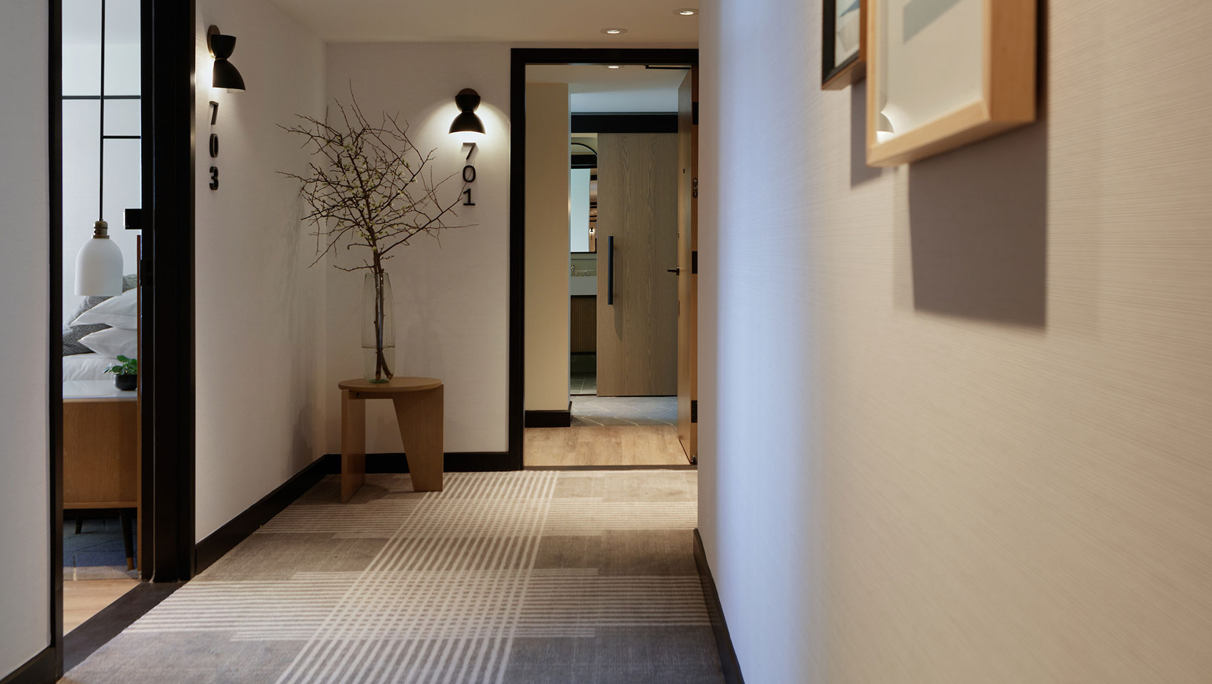 guestroom hallways with wood doors and black accents