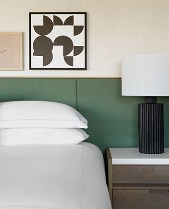 Close up of hotel bed and nightstand